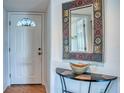 Entryway with white door and ornate mirror at 9359 Blind Pass Rd # 205, St Pete Beach, FL 33706