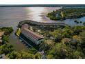 Aerial view of waterfront community with lush landscaping and private boat docks at 115 Brent Cir, Oldsmar, FL 34677