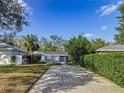 Front view of a blue house with a driveway at 1401 26Th N Ave, St Petersburg, FL 33704