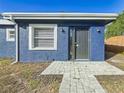 Modern dark gray front door and walkway at 1401 26Th N Ave, St Petersburg, FL 33704