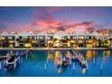 Luxury waterfront townhomes with private docks, illuminated at sunset at 152 Brightwater Dr # 4, Clearwater Beach, FL 33767