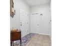 Bright and airy entryway with tile flooring and access to interior rooms at 16020 Starling Crossing Dr, Lithia, FL 33547