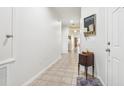 Long hallway with tile floors and access to other rooms at 16020 Starling Crossing Dr, Lithia, FL 33547