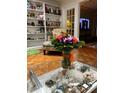 Living room with hardwood floors, built in shelving, and a large bouquet of flowers at 200 Carmona Ne Way, St Petersburg, FL 33704