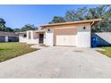 House exterior showcasing a garage, driveway and landscaping at 1257 Waterfall Dr, Spring Hill, FL 34608