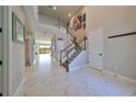 Two-story entryway with marble floors and an open staircase at 12609 Pensacola Ct, Riverview, FL 33579