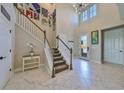 Bright two-story entryway with an open staircase and large windows at 12609 Pensacola Ct, Riverview, FL 33579