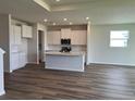 Bright kitchen with white cabinets, granite countertops, stainless appliances, and hardwood floors at 16033 7Th E Ave, Bradenton, FL 34212