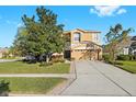 Two-story house with a landscaped yard and a two-car garage at 7860 Atwood Dr, Wesley Chapel, FL 33545