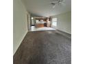 Spacious living room with carpet and kitchen view at 8216 Carriage Pointe Dr, Gibsonton, FL 33534