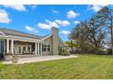 The covered backyard patio features stately columns, a brick patio and ample space for outdoor lounging at 13213 106Th Ave, Largo, FL 33774