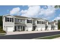 Exterior view of townhomes with attached garages and landscaping at 17440 Haysack Ter, Lakewood Ranch, FL 34211