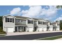 Exterior view of five townhouses with gray siding and white garage doors at 17452 Haysack Ter, Lakewood Ranch, FL 34211