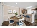 Bright dining area with a round table and four chairs, adjacent to kitchen at 18106 Peregrines Perch Pl # 5204, Lutz, FL 33558