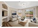 Living room with balcony access, stylish furniture, and recessed shelves at 18106 Peregrines Perch Pl # 5204, Lutz, FL 33558