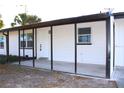 Covered front porch with screened enclosure, new flooring, and fresh paint at 212 Francis Dr, Apollo Beach, FL 33572