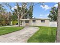 Charming single-story home featuring a well-manicured lawn and a long driveway at 4145 Harrisburg Ne St, St Petersburg, FL 33703