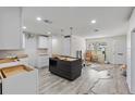 Spacious kitchen featuring new cabinets and modern grey wood-style floors at 4145 Harrisburg Ne St, St Petersburg, FL 33703