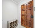 A simple entryway with a wooden door and a shoe rack at 4510 W Mcelroy Ave, Tampa, FL 33611
