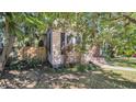 Side view of the house with mature trees and landscaping at 101 22Nd N Ave, St Petersburg, FL 33704