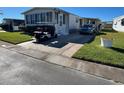 Side view of a manufactured home with a carport and golf cart at 13225 101St St # 425, Largo, FL 33773