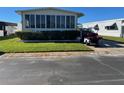 Front view of a manufactured home with a well-maintained lawn at 13225 101St St # 425, Largo, FL 33773
