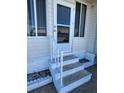 Steps leading to the front door of the home with white railing at 13225 101St St # 425, Largo, FL 33773