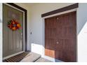 Front entry with a gray door, a brown garage door, and a brick walkway at 16819 Shell Bay Dr, Land O Lakes, FL 34638
