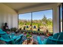 Relaxing sunroom with comfy chairs, plants, and large windows at 16819 Shell Bay Dr, Land O Lakes, FL 34638
