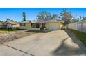 Single-story home with attached garage and a spacious driveway at 1710 Georgia Ne Ave, St Petersburg, FL 33703