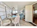 Bright sunroom with glass table, wicker chairs, and a comfy sofa at 18675 Us Highway 19 N # 232, Clearwater, FL 33764
