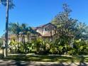 Two-story house with a driveway and lush landscaping at 4015 Woodacre Ln, Tampa, FL 33624