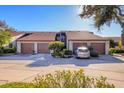 Two-story condo building with brown roofs, attached garages, and landscaping at 4542 Park Lake N Ter # 4542, Bradenton, FL 34209