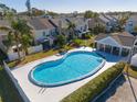 Community pool with a kidney shape and a covered patio area at 6740 121St Ave # 6, Largo, FL 33773