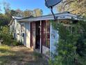 Small house with red doors and satellite dish at 10128 Loy St, New Port Richey, FL 34654