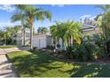 Exterior of house with palm trees and well maintained lawn at 21434 Preservation Dr, Land O Lakes, FL 34638