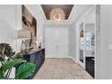 Bright entryway with tile floors, a console table, and chandelier at 2847 Calvano Dr, Land O Lakes, FL 34639