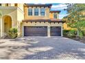 Two-car garage with a brick paved driveway at 2847 Calvano Dr, Land O Lakes, FL 34639