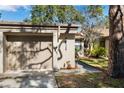 Attached garage with a light tan exterior at 2902 Oak Cir, Tarpon Springs, FL 34689