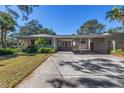 Home's exterior view, featuring a carport and spacious driveway at 4925 Alcazar S Way, St Petersburg, FL 33712