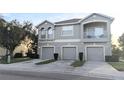 Two-story townhome with three-car garage and balcony at 9060 Moonlit Meadows Loop, Riverview, FL 33578