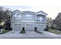 Two-story townhome with three-car garage and balcony at 9060 Moonlit Meadows Loop, Riverview, FL 33578