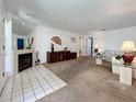 Bright living room with fireplace and neutral carpeting at 10626 Longwood Dr # 103, Seminole, FL 33777