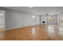 Bright and airy living room with hardwood floors and a cozy fireplace at 1321 Riverside Dr, Tarpon Springs, FL 34689