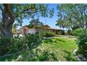 Well-manicured lawn with mature trees surrounding the property at 1997 Kansas Ne Ave, St Petersburg, FL 33703
