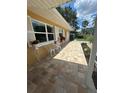 Inviting front entrance with a tiled walkway and decorative flower planters, adding charm and curb appeal at 209 Westwinds Dr, Palm Harbor, FL 34683