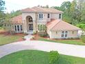 Two-story house with tile roof and a large yard at 3050 Wentworth Way, Tarpon Springs, FL 34688