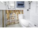 Bathroom under renovation, features a toilet and shower with marble-style wall tiles at 4501 Helena Ne St, St Petersburg, FL 33703