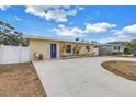 Charming one-story home with a circular driveway, blue door, and manicured landscaping, creating inviting curb appeal at 6366 38Th N Ave, St Petersburg, FL 33710