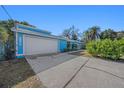 White garage door and light blue exterior wall of the house at 7108 Riverwood Blvd, Tampa, FL 33615